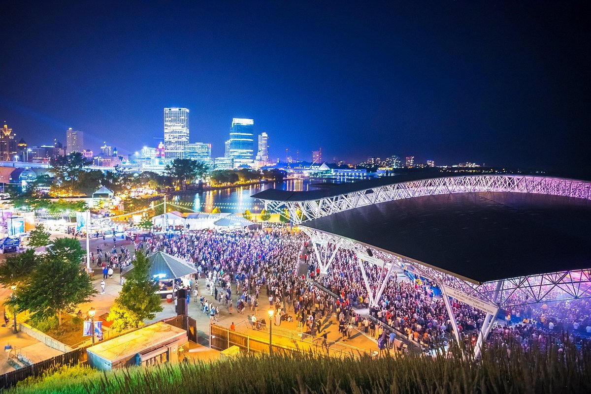 Summerfest Milwaukee night aerial view with city skyline and massive crowd